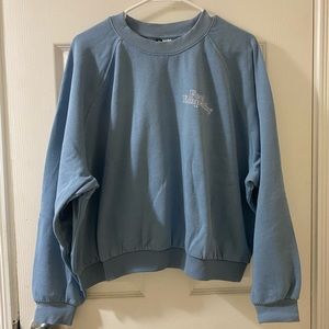 Women’s Cropped Sweatshirt in powder blue, gently worn, “Feel Empathy”
